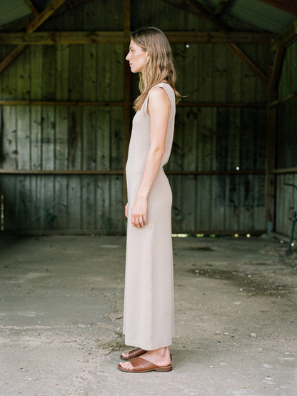 Sleeveless knitted maxi dress in Thatch worn in profile, cotton rib column to the ankle