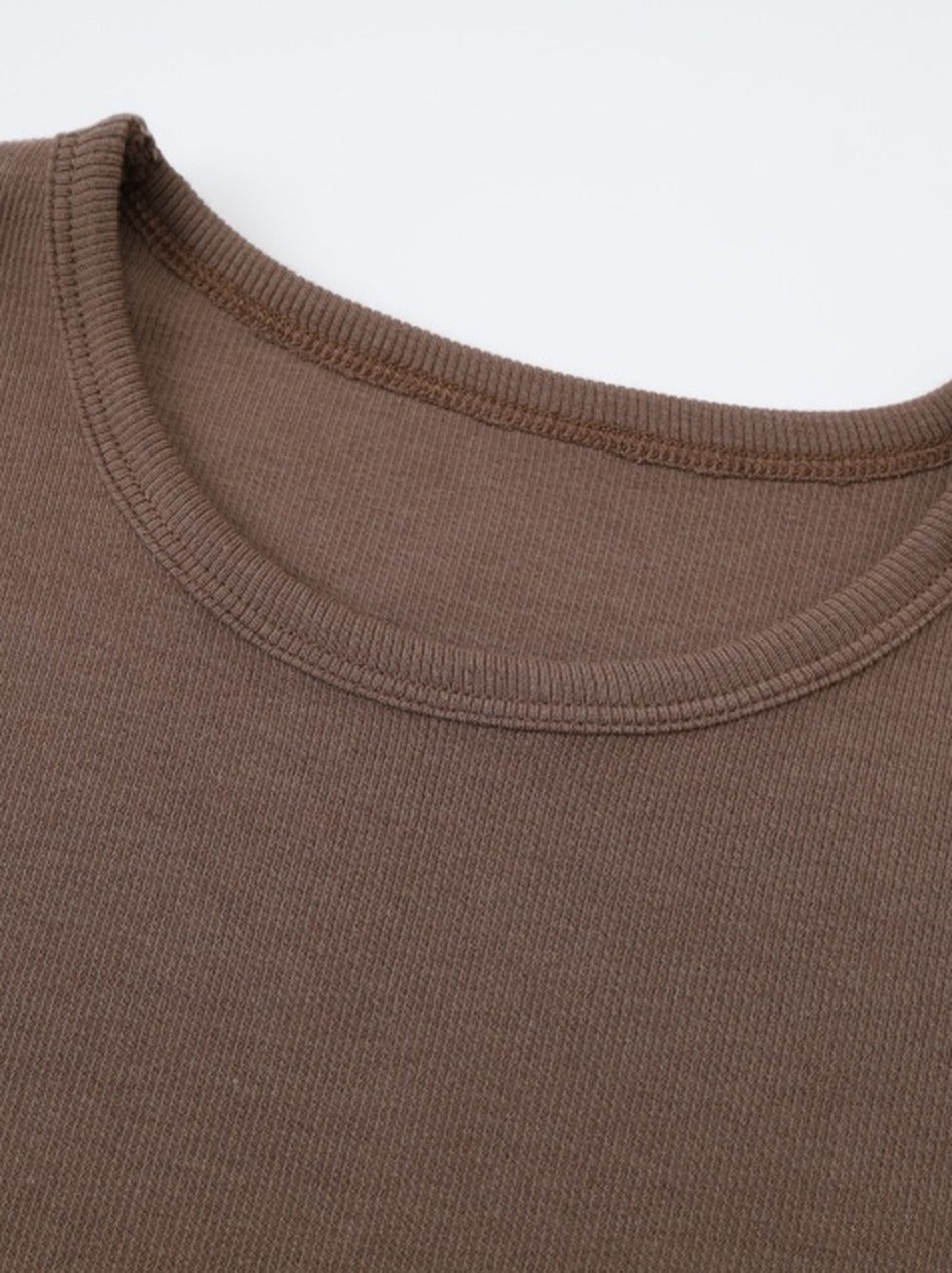 Ribbed crew neckline of the brown maxi dress, bound with a narrow band of the same knit