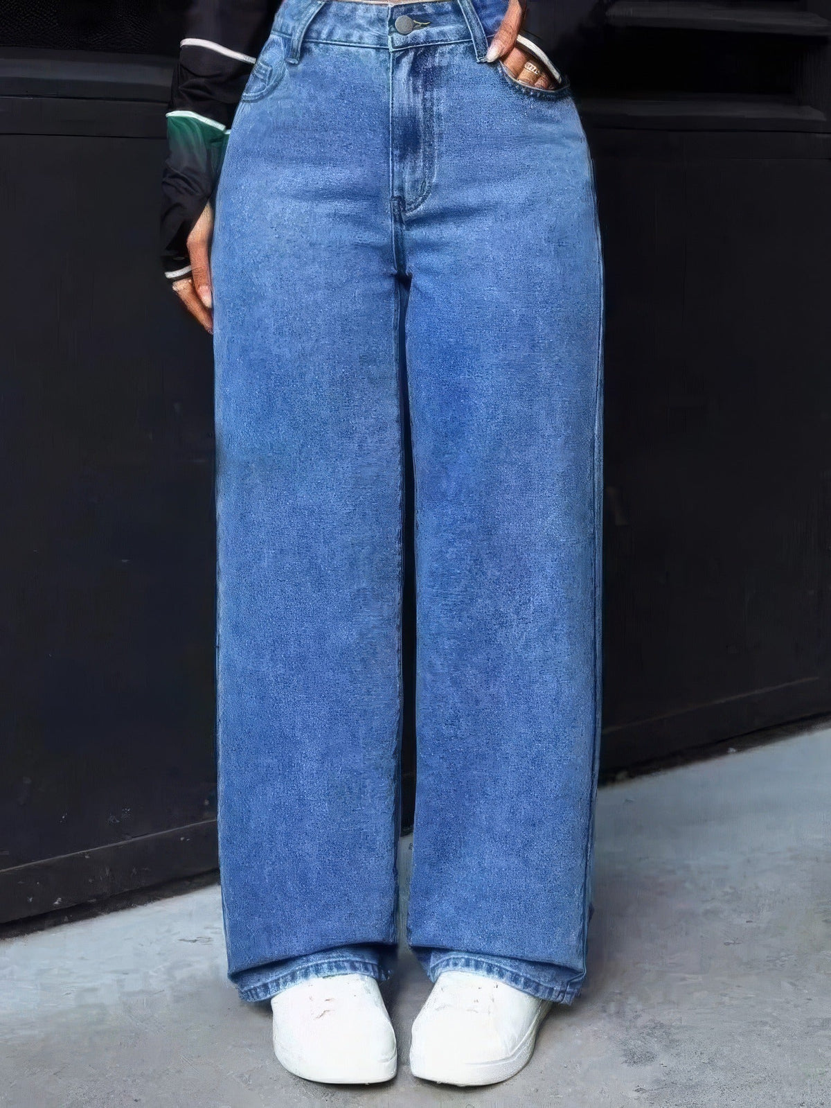 Mid Blue wide-leg jeans worn full length with white trainers