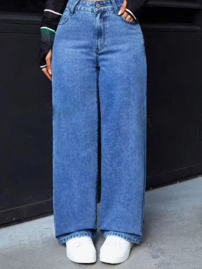 Mid Blue wide-leg jeans worn full length with white trainers