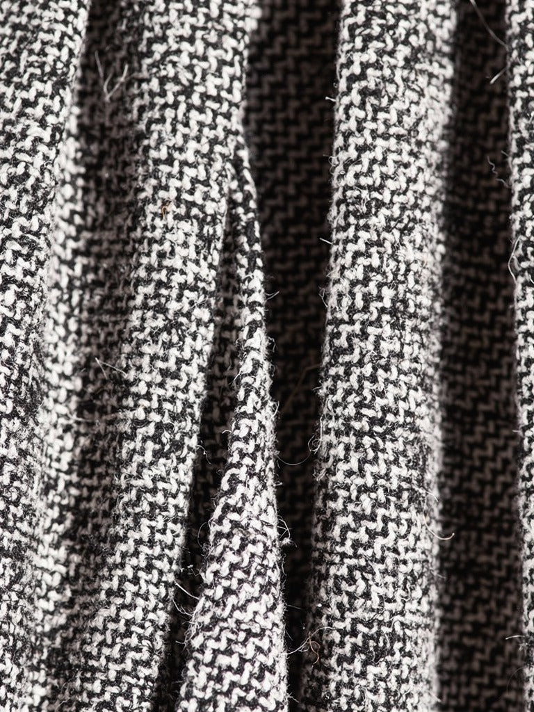 Close up of the black and white herringbone weave of the A line skirt, the zigzag lines woven from black and off white yarn