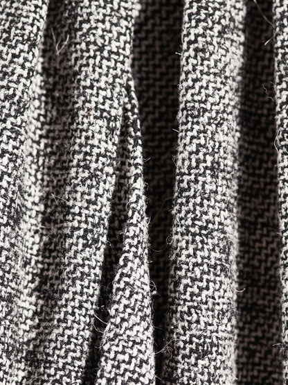 Close up of the black and white herringbone weave of the A line skirt, the zigzag lines woven from black and off white yarn