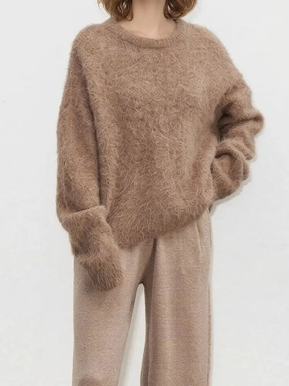 Cappuccino alpaca jumper worn loose over knitted trousers, showing the oversized body and long cuffs