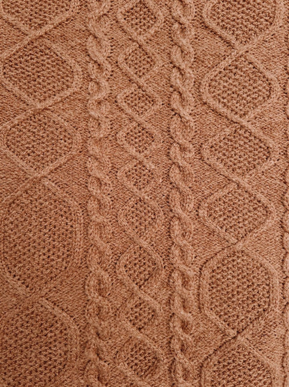Close-up of the Aran diamond and rope cable texture of the camel knitted dress