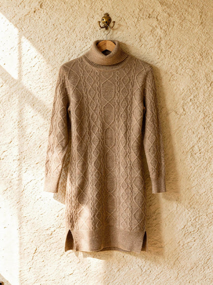 Camel Aran cable-knit polo-neck jumper dress on a wooden hanger