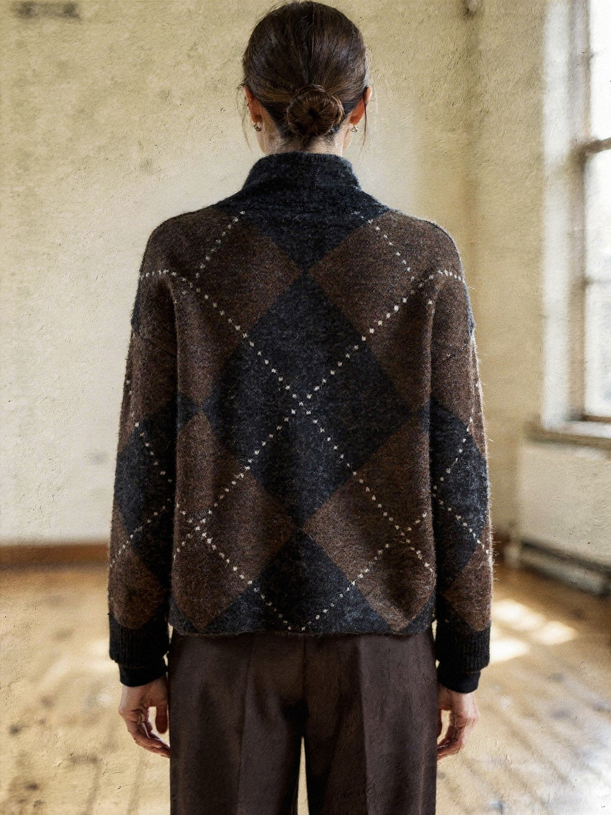 Back of the argyle jumper showing the pattern running across the back and the ribbed cuffs