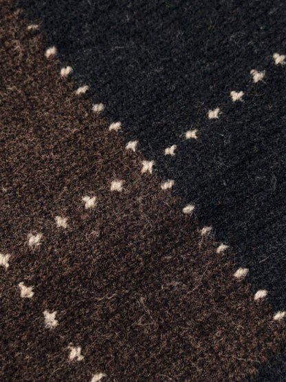 Close up of the brushed argyle knit, chocolate brown and black diamonds with fine cream dotted lines