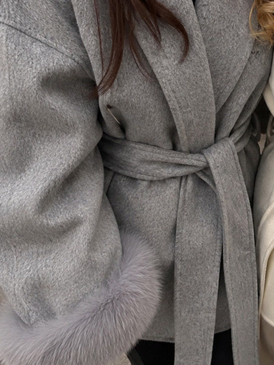 Tie belt knot and faux fur cuff of the Flint grey belted coat