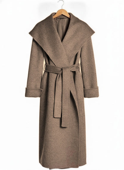 Belted wrap coat in Hickory taupe on a wooden hanger, showing the deep shawl collar, the tied belt and the deep turn back cuffs