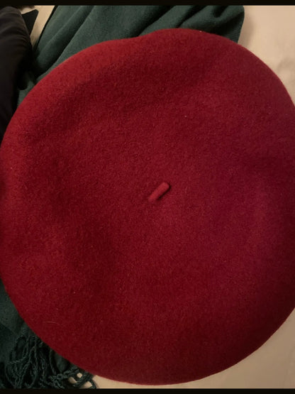 Rosehip beret hat laid flat, seamless felted crown with a small topknot at the centre
