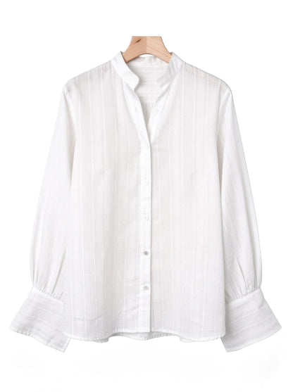 White bishop-sleeve tunic shirt in self-stripe voile on a wooden hanger, front view