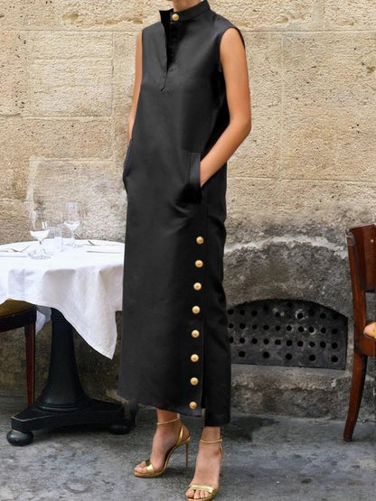 Black column dress worn full length, three quarter view