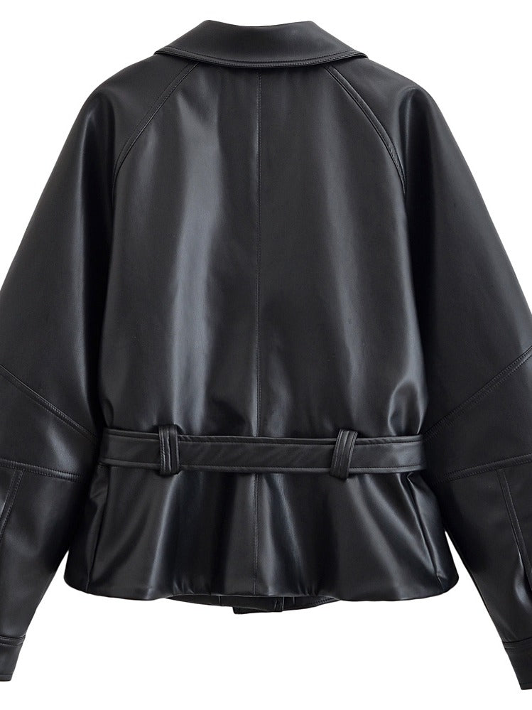 Back view of the black faux leather jacket showing the belt loops and the flared peplum hem