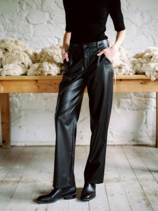 Black faux leather trousers worn full length in Pitch Black