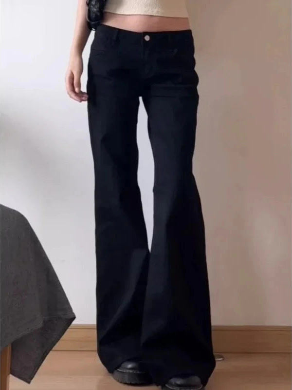 Womens low-rise flared black jeans worn with platform boots - Brackley