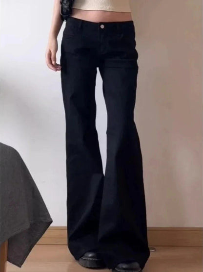 Womens low-rise flared black jeans worn with platform boots - Brackley