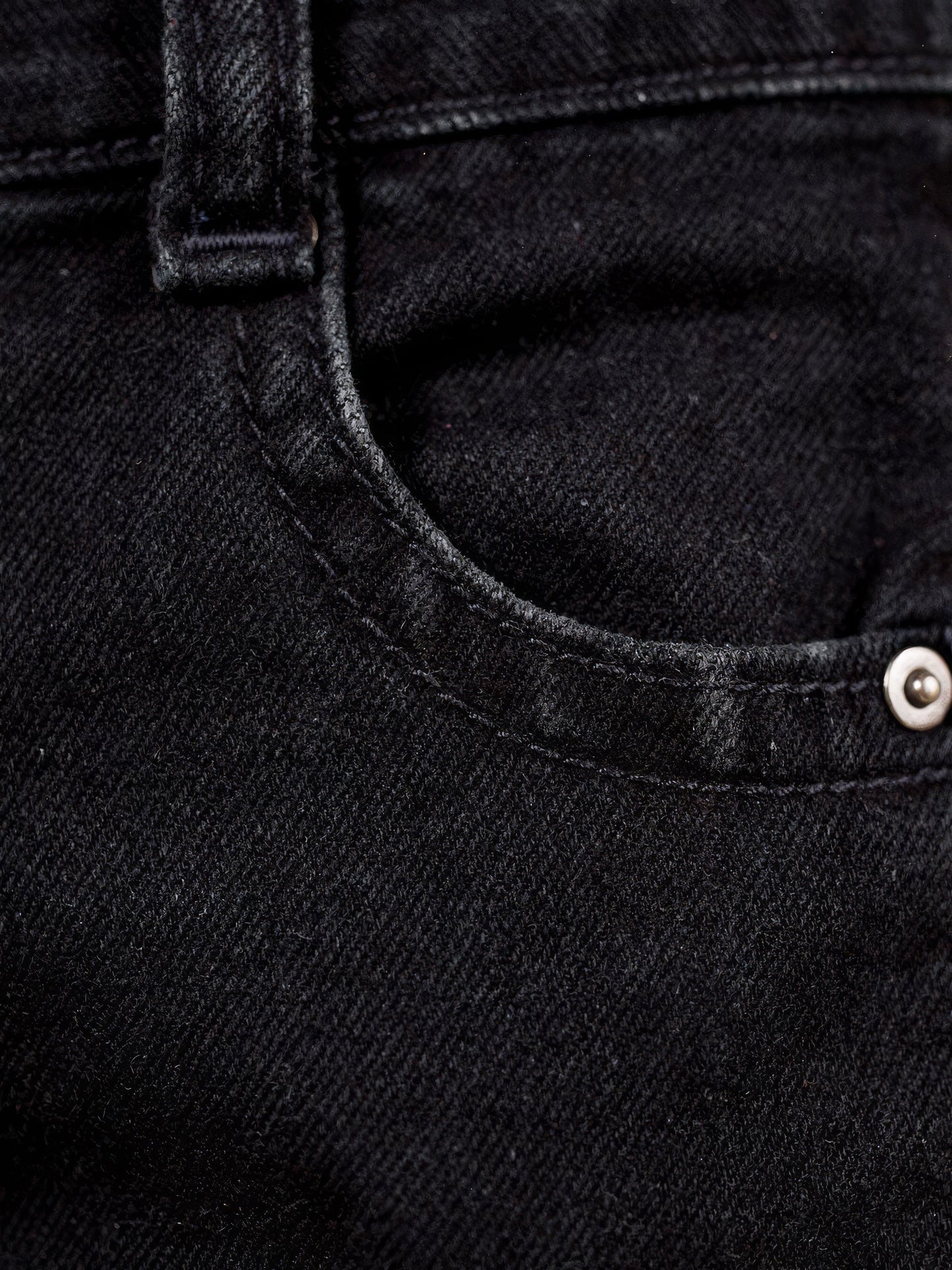 Washed black denim close-up with five-pocket and topstitch detail - Brackley