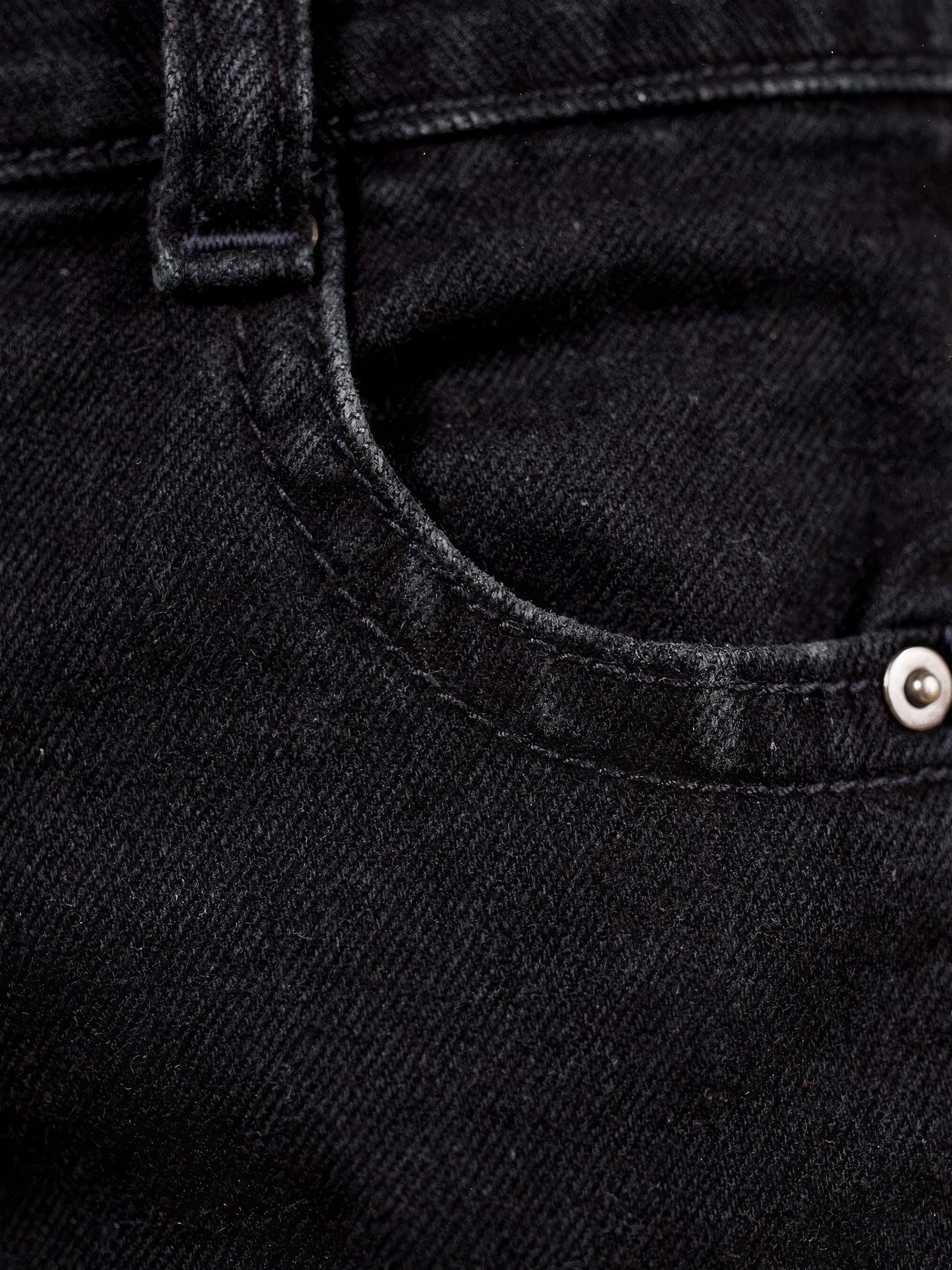 Washed black denim close-up with five-pocket and topstitch detail - Brackley