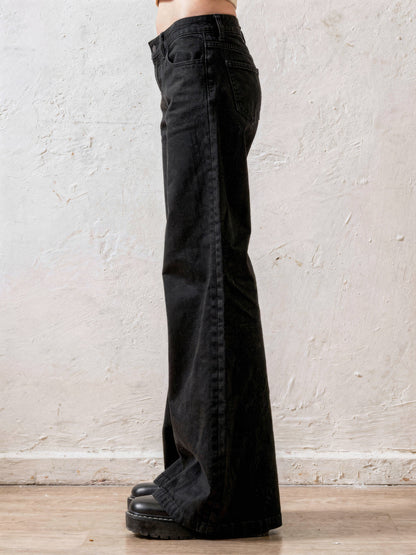 Black flare jeans side profile showing the wide flare drape - Brackley