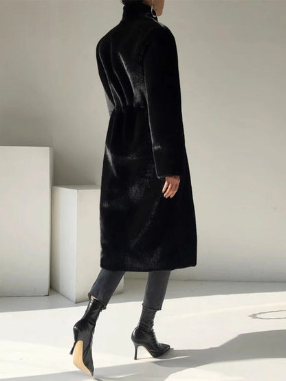 Black fluffy coat seen from the back, showing the stand collar and the gathered back waist
