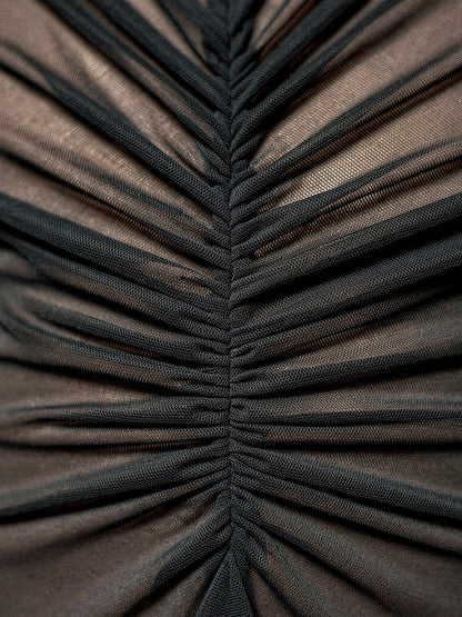 Close-up of the fine ruched mesh on the black maxi dress
