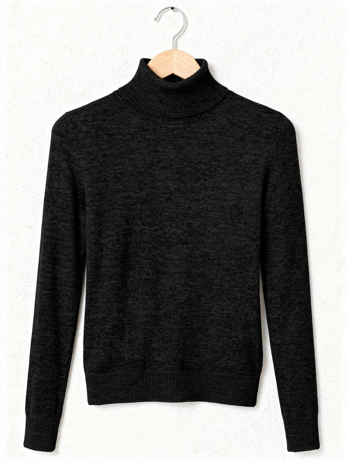 Black roll neck jumper on a wooden hanger, fold-over ribbed collar and fine knit