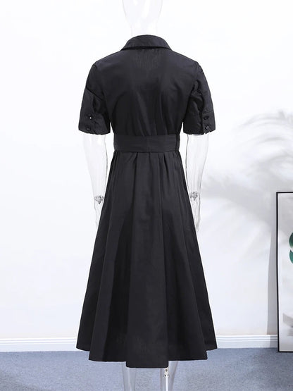 Back of the black shirt dress showing the buttoned tab cuff