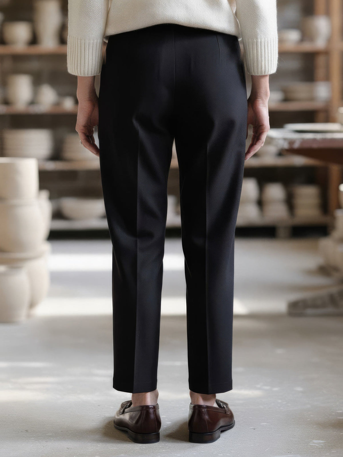 Back view of the black cigarette leg trousers, showing the plain back with no pockets