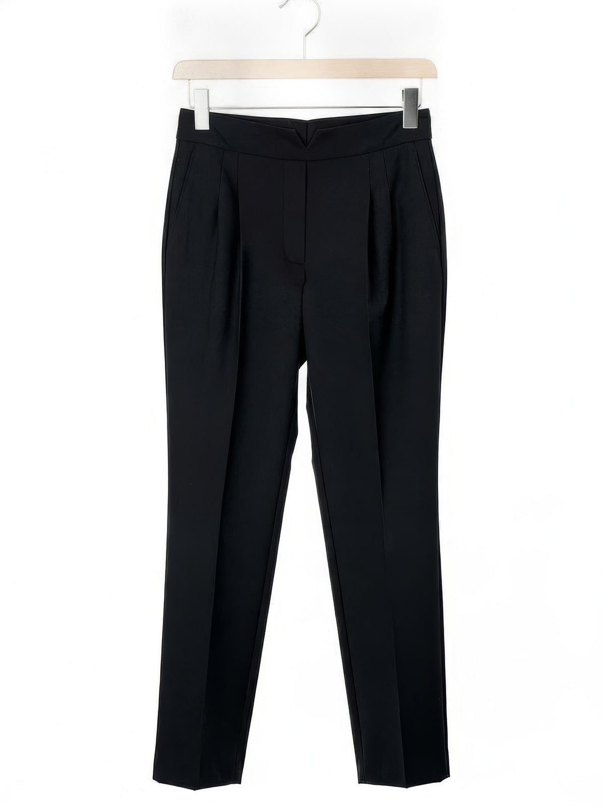 Black cigarette leg trousers shown in full on a wooden hanger
