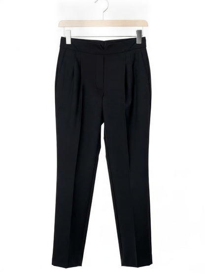 Black cigarette leg trousers shown in full on a wooden hanger