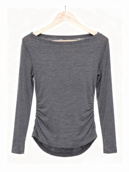 Smoke grey boat neck top on a hanger showing the wide slash neckline and the ruched side seams