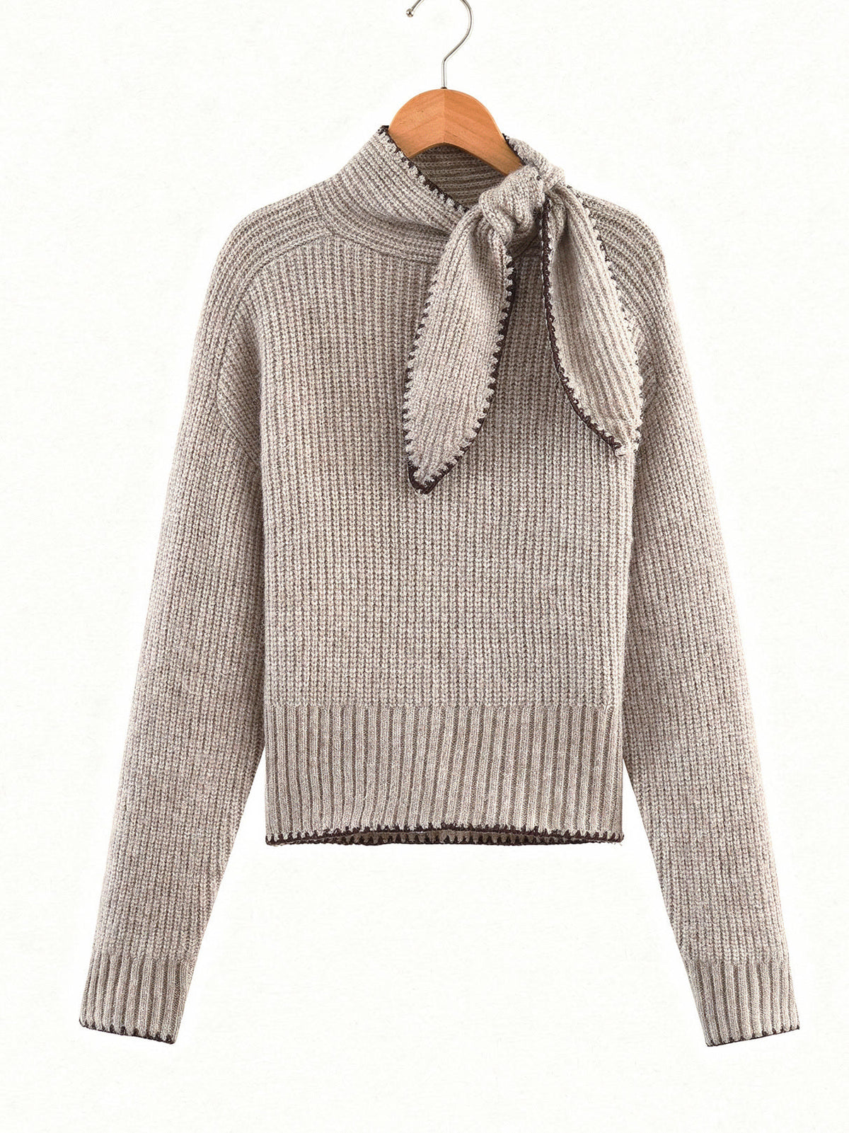 Bow neck jumper in Cashew on a wooden hanger, stand collar and knitted tie in a bow
