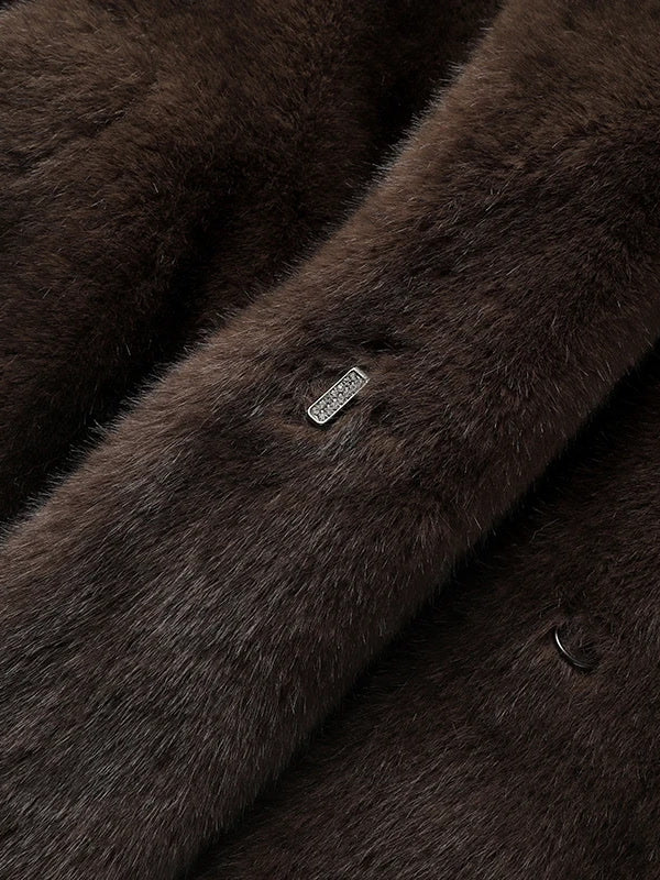 Detail of the crystal set hook fastening on the front of the brown faux fur coat