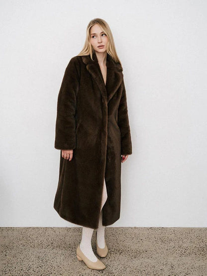 Brown faux fur coat worn open in the studio, full length from the shoulders to the shoes