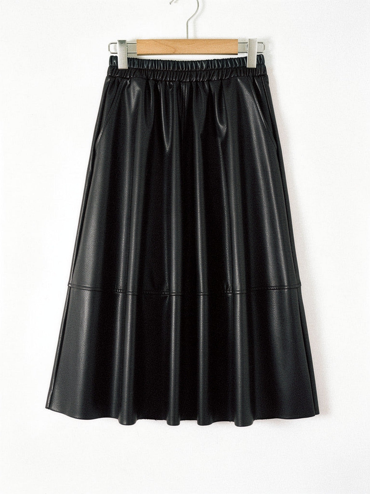 Faux leather skirt in Black shown front on with the same gathered waistband, slanted side pockets and full A line