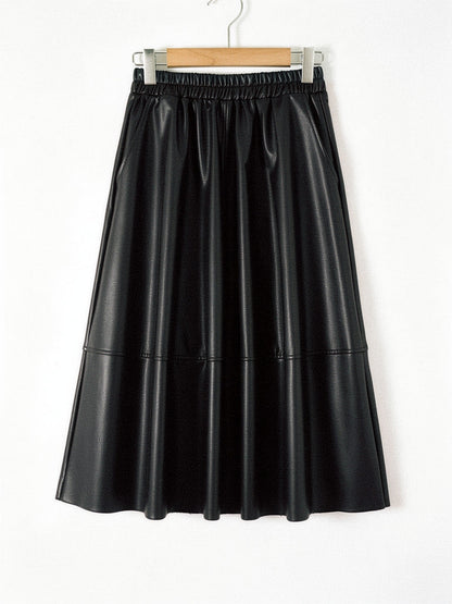 Faux leather skirt in Black shown front on with the same gathered waistband, slanted side pockets and full A line