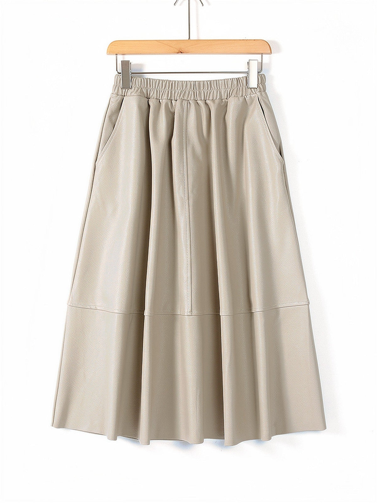 Faux leather skirt in Buff, a quiet pale sand, shown front on with the same gathered waistband and full A line