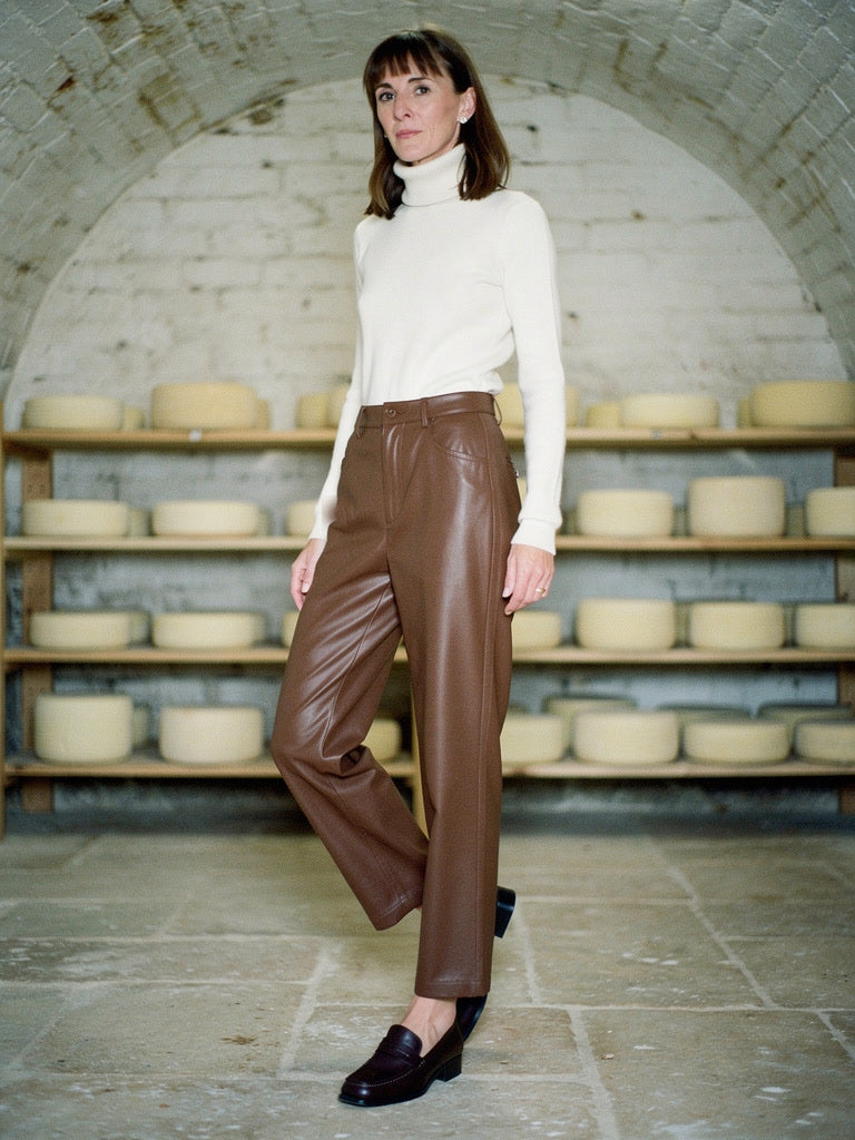 Brown faux leather trousers in Toffee worn with a cream roll neck jumper