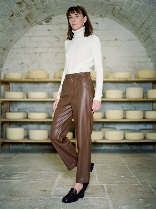 Brown faux leather trousers in Toffee worn with a cream roll neck jumper