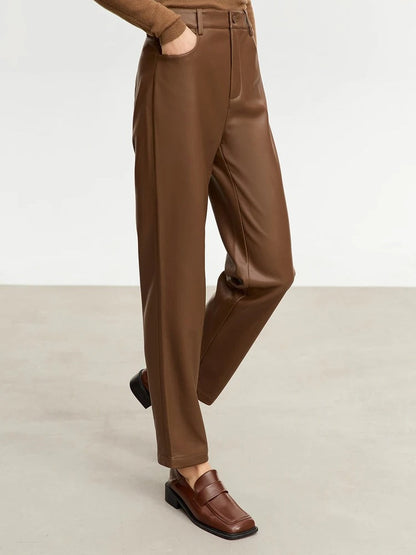 Brown faux leather trousers in Toffee worn walking, three quarter view