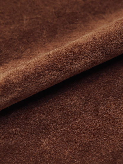 Close up of the faux suede cloth of the skirt, showing the fine matte brushed nap and a soft rolling fold