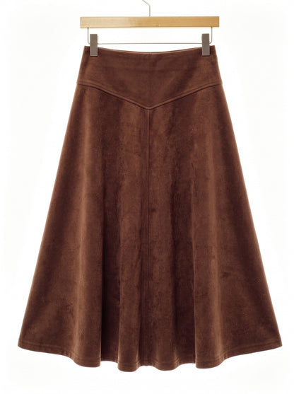 Brown faux suede skirt in Tamarind shown front on, the wide waistband, its chevron seam and the full flare to the hem all visible