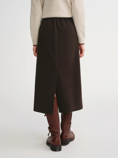 Back of the brown A line midi skirt showing the elasticated waistband and the centre back vent