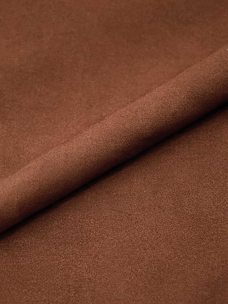 Close-up of the matte twill cloth of the Russet brown trousers
