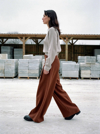 Brown wide-leg trousers in Russet worn walking, full length