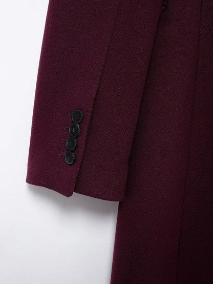 Close up of the four button cuff and the fine diagonal twill weave of the burgundy coat