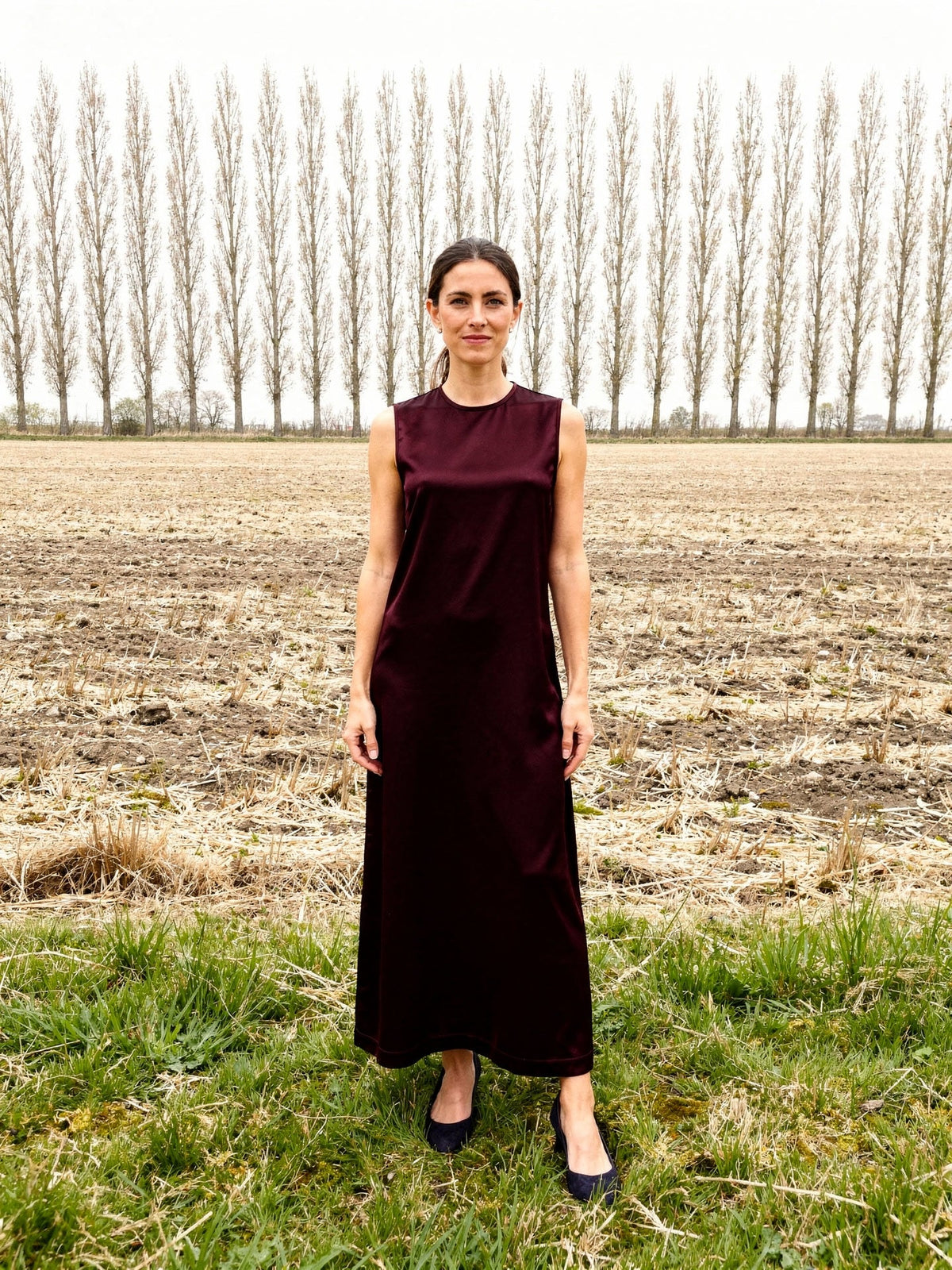 Burgundy dress in Claret satin, sleeveless ankle length column, worn front view