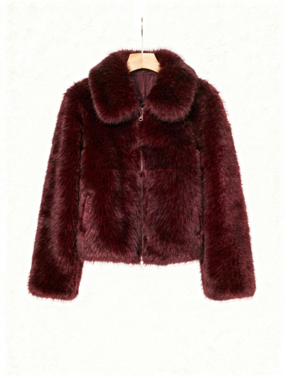 Burgundy faux fur jacket on a wooden hanger, front view with the centre zip closed