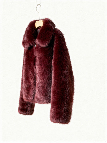 Burgundy faux fur jacket on a hanger, three quarter view showing the dropped shoulder and sleeve