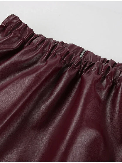 Elasticated gathered hem of the burgundy faux leather jacket